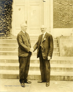 Two members of Kappa Sigma shake hands on the 50th Anniversary held in Charlottsville, Va.