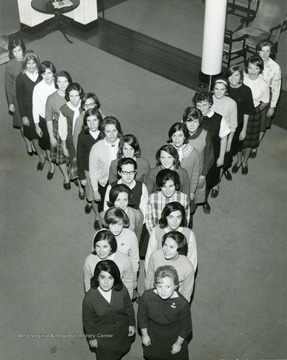 Members of YWCA making a Y-formation for a group photo in Elizabeth Moore Hall.