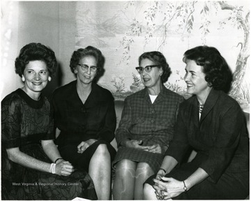 President Miller's wife is sitting on far left, at a planning meeting for the Campus Club opening tea held on October fourth at the president's home.