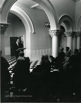 Robert Munn, former Dean of Libraries speaks at the dedication of Stewart Hall; President Stewart on right in the audience. 