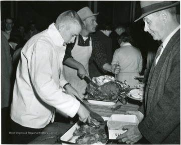 A man stands in line for a good cut of meat.