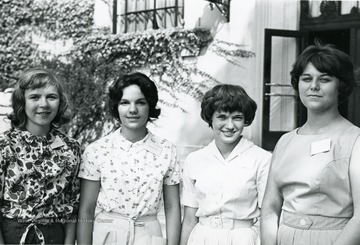 Attendees of library science workshop held at West Virginia University: from left to right Lisa Gresko, Karen Sue, Laura Webb and Linda Truban.  The photo is taken outside of Wise Library.