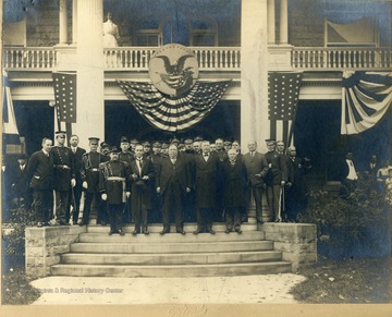 President William Howard Taft, front row center, delivered the inaugural speech Nov. 1, 1911, when Thomas Edward Hodges, became president of the University.  Identified front row, left to right, are Daniel B. Purinton, Gov. W.E. Glasscock, President Taft, Thomas E. Hodges and Dr. I.C. White.  Left, 2nd row: Judge Frank Cox, Henry Green, editor of the Morgantown Post.  The first two men pictured in the back row could not be identified, third is James L. Lakin, fourth Maj. Butts, who lost his life in sinking of Titanic; fifth, Mr. Sigwart; sixth George C. Baker; seventh, H.C. Batton; eight and ninth, unidentified; 10th Harry Carspecken; and others, M. L. Brown, William Williams, E. Donley, Benjamin Rosenbloom, Frank B. Trotter and Dr. A.M. Buckhannon.  The men in uniform were members of the Governor's Staff.'