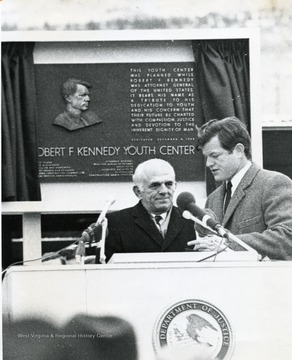 Senator Edward Kennedy visits W. Va. for opening of Robert F. Kennedy Youth Center, shown here is the senator in front of a dedication plaque.
