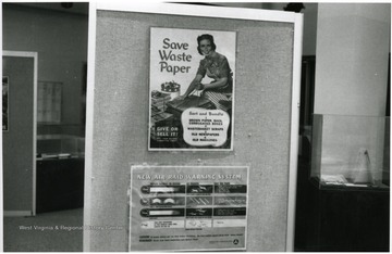 Exhibit in second floor gallery, Mountainlair.  Posters say, 'Save waste paper.  New air raid warning system.'