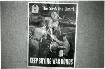 Exhibit in second floor gallery of Mountainlair. Poster says, 'The sky's the limit, keep buying war bonds'.