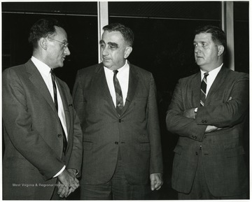 'Professor of physics-at-large and legendary 'Father of the H-Bomb' Edward Teller (center) chats with symposium planning committee chairman, Guy Stewart (right), and moderator John Troan, editor of The Pittsburgh Press (left).