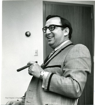 Buchwald with a cigar in his hand.