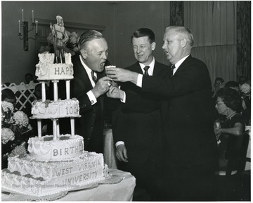 '100th Anniversary Birthday Dinner Cake-Cutting ceremonies.  Left to right are: Gov. Hulett Smith, acting WVU President Harry B. Heflin, and Congressman Arch A. Moore.'