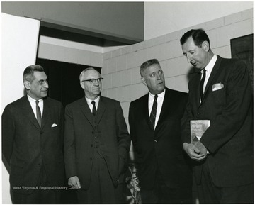 'Famed Kentucky author Jesse Stuart (second from right) chats with WVU professors John Caruso, prof. of history and chairman of the symposium planning committee (left); J.P. Brawner, prof. of English (second from left); and Ruel Foster, prof. and chairman of English (right) at the Feb. 22-24, 1967 'Lessons of History,' symposium.'