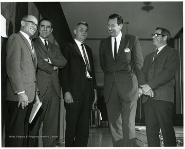'Chancellor of Vanderbilt University Alexander Heard (second from left) is shown chatting with seminar committee chairman J. Clifford Stickney, WVU prof. of Physiology and Biophysics (left); Robert Stilwell, WVU prof. of German and chairman of Foreign Languages (center); Ruel Foster, WVU prof. and chairman of English (second from right); and George Nocito, WVU prof. and chairman of Art.  Stilwell, Foster and Nocito served as panelists a the Nov. 28, 1967 seminar on the Future of Undergraduate Education at WVU.' 