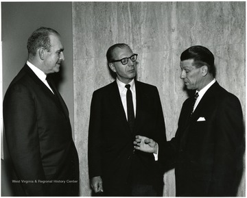 'Famed CBS correspondent Richard C. Hottelet (center) is shown chatting with WVU Acting President Harry B. Heflin (right) and Roman J. Verhaalen, Dean of the Kanawha Valley Graduate School (left) prior to Hottelet's Mar. 13, 1967 lecture on the International Emphasis Series.'