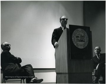 'Famed CBS correspondent Richard C. Hottelet is shown at the Mar. 13, 1967 International Emphasis Series Program.  Also shown are Donovan H. Bond, exec. dir. of the 100th Ann. observance (left), and Roman Verhaalen, Dean of the Kanawha Valley Graduate Center (right).'