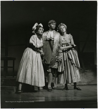 Two female actors flank a male actor.