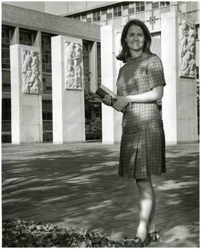 'Parents: Mr. and Mrs. James M. Poindexter. Senior Nursing major. Activities: president of Alpha Xi Delta sorority, chosen as a 1967 Mountaineer Illustrated Cover Girl, Student Nurses Association, Associated Women Students Judiciary Board, Student Legislature. In the background is the pylons at WVU Medical Center.'