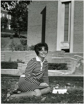 'Parents: Mr. and Mrs. Andrew Sotok, Jr. Senior Elementary education major. Activities: Alpha Ki Delta social sorority, 1967 Military Ball Queen, Student Education Association, Registered Nurse. In the background Lower Quadrangle of WVU's main campus showing Armstrong Hall.'