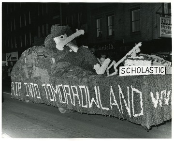 Scholastic float with a Mountaineer in Homecoming parade.
