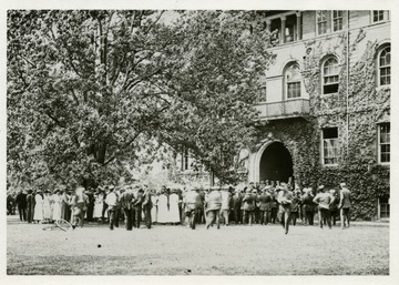A scene from Spring 1917, as students gather in front of Chitwood Hall protesting the faculty's decision to continue with final exams after the United States had declared war on Germany. Many schools across the country had canceled finals since most male students would be drafted or enlist in quick order.