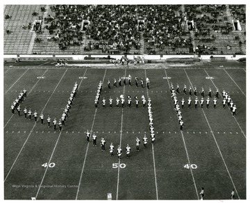 An aerial view of WVU marching band spelling 'USA' on the field.