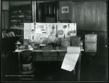 A view of Home Economic Room shows a display of kitchen tools and equipment. 