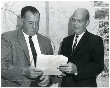 Planning office workers examine a document.