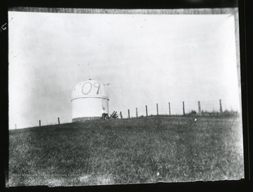 Unidentified student sits next to the Observatory which has '09 painted on it.