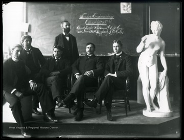A portrait of class of 1898, senior students of civil engineering; a male standing is Elmer Leach, the rest are unidentified. 