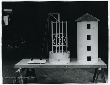 A display of model of silo and a pulley structure.