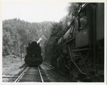 Image from the collection of the Chesapeake and Ohio Historical Society. 'CSPR-308; C. &amp; O. H-6 2-6-6-2 Mallet #1479 passing #1445 on Piney Creek branch.'