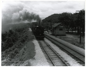 Image from the collection of the Chesapeake and Ohio Historical Society. 'CSPR-1472: C.&amp; O. H-5, 2-6-6-2, Mallet #1521 passing tiny frame station at Brent, Ky. with merchandise freight train.'