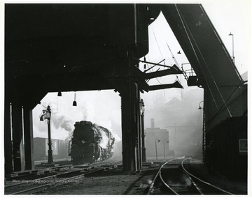 Image from the collection of the Chesapeake and Ohio Historical Society. 'CSPR-449; K-4 Kanawha #2716 under the coal dock at Hinton, W. Va. in misty early morning, March 1946.'