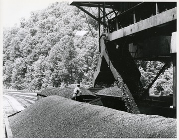 Image from the collection of the Chesapeake and Ohio Historical Society. 'Negative CSPR-3423: A closeup view of coal being loaded into c/0 hoppers at Guyan Eagle Coal C. Guyan #5 mine Kelly, W. Va.'