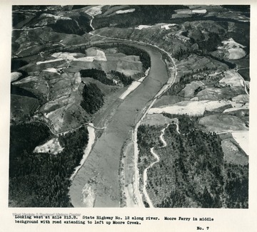 'Looking west at mile 213.8.  State Highway no. 12 along river.  Moore Ferry in middle background with road extending to left up Moore Creek.