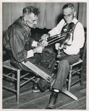 'The ancient technique of 'beating the strings.' Andrew Burnside bows the melody while Gilbert Massey beats the strings. The music has a vaguely oriental flavor, but the tune 'Hell up Cold Holler' is as occidental as Bourbon and branch water.'