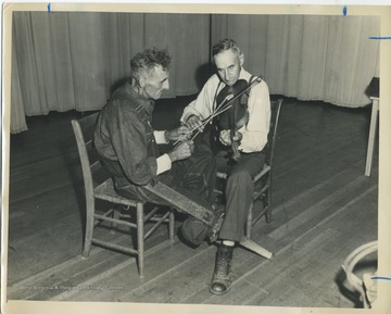 'The ancient technique of 'beating the strings.' Andrew Burnside bows the melody while Gilbert Massey beats the strings.'