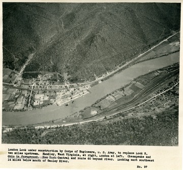 'London Lock under construction by Corps of Engineers, U.S. Army, to replace Lock 2, two miles upstream.  Handley, West Virginia, at right, London at left.  Chesapeake and Ohio in foreground.  New York Central and route 60 beyond river.  Looking east southeast 14 miles below mouth of Gauley River.'