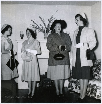 Four girls wearing dresses.