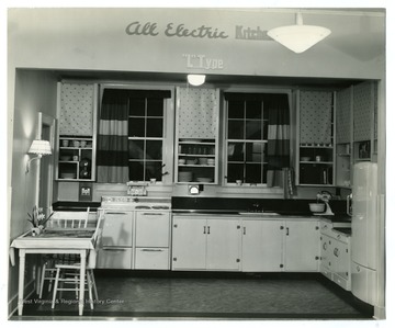 A close-up view of 'L' type kitchen equipped with modern electric appliances.