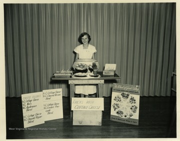 Likely pictured is 'Dorothy Lanham, Marshville,' who 'placed first in the Dairy Foods Demonstration contest.  The 2 teams entered both received red ribbons.'  See original for more information on Harrison County 4-H Contest for 1949.