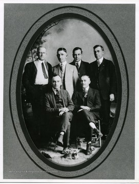 'Standing from left: Hines Peevy (from Pa.), Ira D. Cox.  All others unidentified were also from Pa., interested in obtaining oil and gas leases in W. Va.'