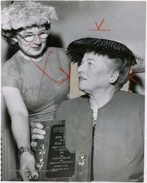 'Pearl Buck (right) receives Award of Distinction plaque from Mrs. Milton Halin at luncheon of Ruth Marks Magilner Chapter, B'nai B'rith Women's Council.'
