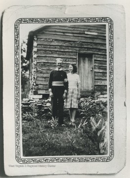 Emma and her husband Thomas Earl Triplett, in front of one room school house in Hill's Creek, W. Va.