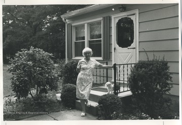 Emma Hammons at her house in Pasadena, MD with a dog.