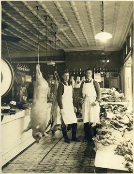 Located on High and Pleasant Streets. On the left is Orton Dwight Federer 'brother' of Cleveland, Ohio and on the right is Cecil Sprouse of Richmond Virginia. In the background, an unidentified Black man stands behind the counter.