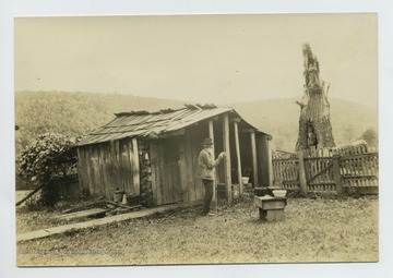 'The spring which was to the back of Nancy Hanks home. Note crock on top of spring. Mr. Joseph Doll drinking.' Coyd Yost Photographer. Keyser, W.Va.