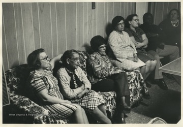 Group of men and women sit in Chestnut Ridge Methodist Church, Philippi, W.Va.
