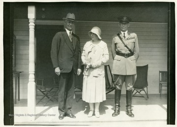 Governor Conley standing outside a building with a man in uniform and woman.