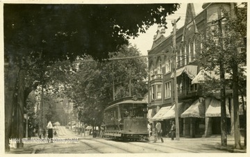 A view of High Street, Morgantown, W. Va.; pedestrians, a trolley car