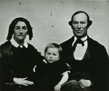 A portrait of a man and woman with a child from the Ellison-Dunlap families of Monroe County. 'Great grandfather Kyle Family: Thomas Daggs(?) Kyle with parents. Thomas Daggs(?) Kyle was Emma Kyle Ellison's Father.'