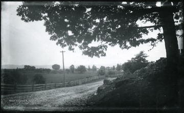 '116.D.(70); August 1, 1884, Friday 10-25 am; bright sun; Camera stands at the entrance to the grounds of a fine old house on the right hand. Boy on horseback just behind the camera wanted to be taken, sorry I didn't. View is looking East at Berryville. The Pike turns at right angle toward the left to Harpers Ferry.'